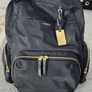TUMI Black Backpack with Gold Accents